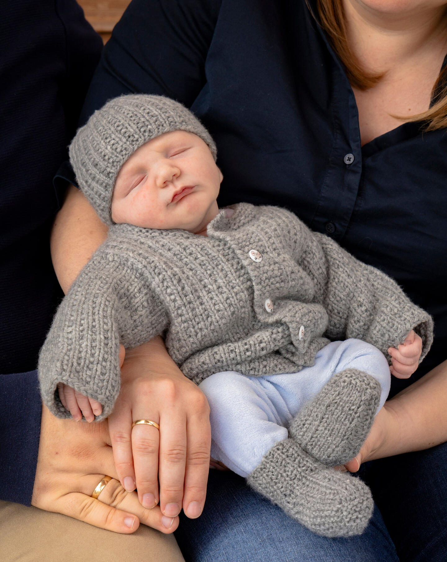 sleeping baby in the arms of his parent